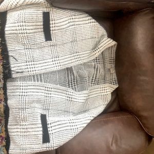 This is a new without tags Chico’s poncho with sleeves.